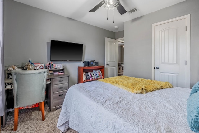 carpeted bedroom featuring a ceiling fan and visible vents