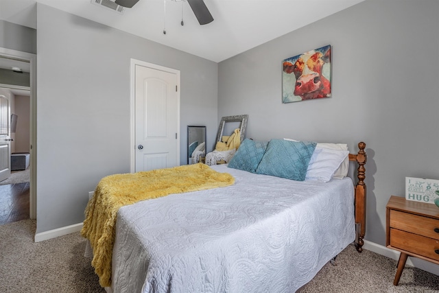 carpeted bedroom with a ceiling fan, visible vents, and baseboards