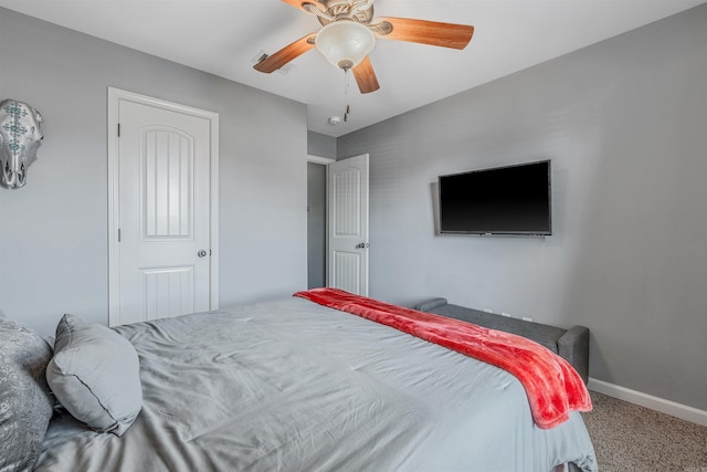 carpeted bedroom featuring ceiling fan and baseboards