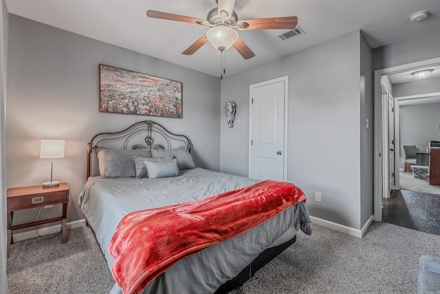 carpeted bedroom featuring baseboards, visible vents, and ceiling fan