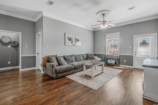 living area featuring a ceiling fan, visible vents, crown molding, and hardwood / wood-style flooring