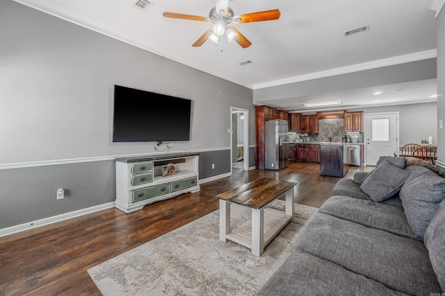 living room with baseboards, crown molding, visible vents, and dark wood-type flooring