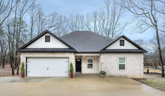 view of front of property with concrete driveway, brick siding, an attached garage, and roof with shingles