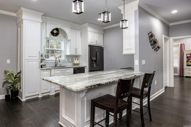 kitchen featuring a sink, white cabinetry, ornamental molding, light stone countertops, and black refrigerator with ice dispenser