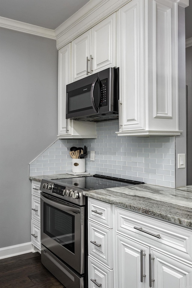 kitchen with white cabinets, stainless steel range with electric cooktop, crown molding, and backsplash