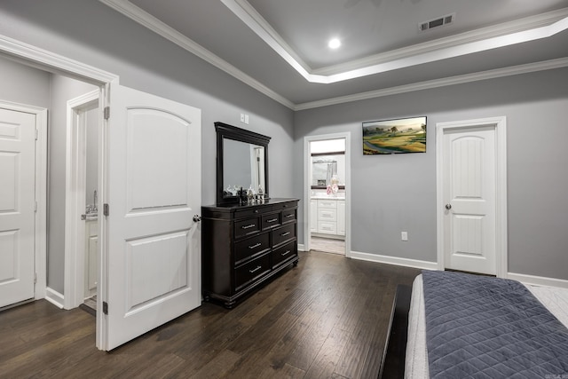 bedroom featuring visible vents, a raised ceiling, dark wood-style flooring, and ornamental molding