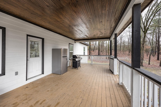 wooden terrace featuring grilling area