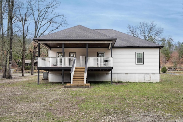 rear view of property with a shingled roof, crawl space, a yard, and stairs