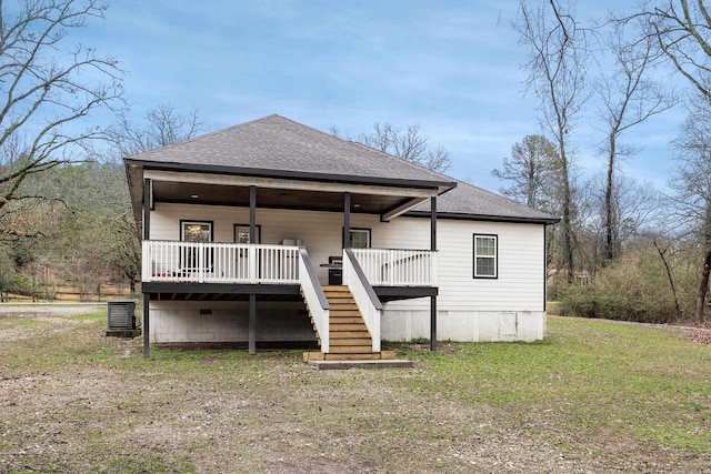 view of front of property featuring stairway, roof with shingles, and a front yard