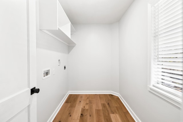 clothes washing area featuring light wood-style flooring, laundry area, washer hookup, baseboards, and electric dryer hookup