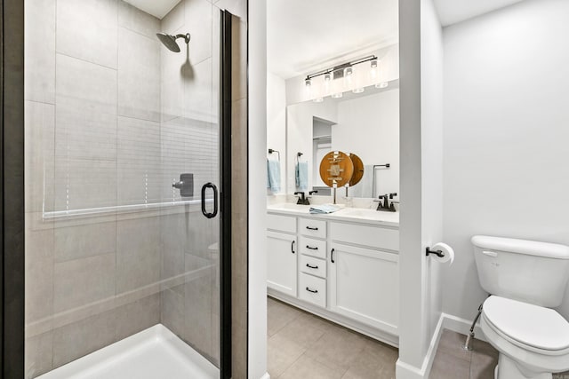 full bath with double vanity, toilet, a stall shower, a sink, and tile patterned floors