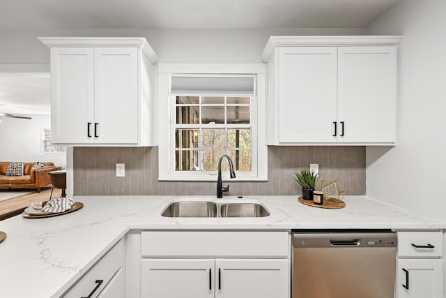 kitchen with a sink, white cabinetry, and dishwasher