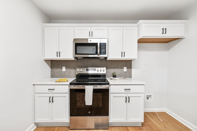 kitchen featuring tasteful backsplash, appliances with stainless steel finishes, and light countertops