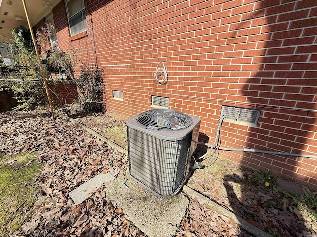 details with crawl space, central AC, and brick siding