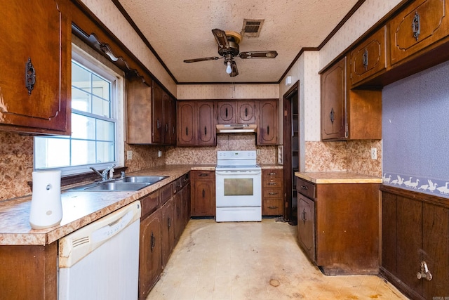 kitchen featuring light floors, white appliances, a sink, and visible vents