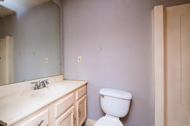 bathroom with toilet and vanity