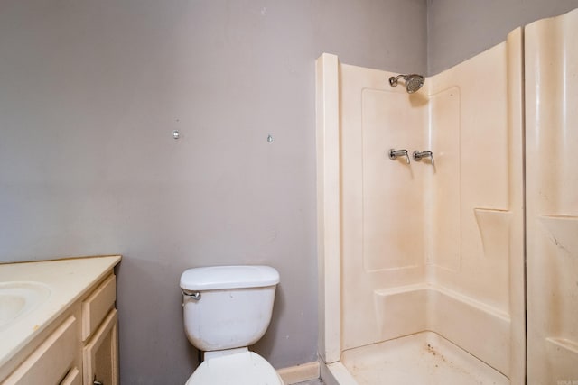 bathroom with toilet, a shower, and vanity