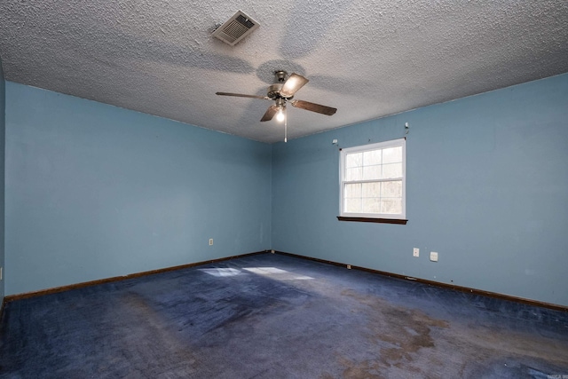 carpeted empty room with a ceiling fan, visible vents, a textured ceiling, and baseboards