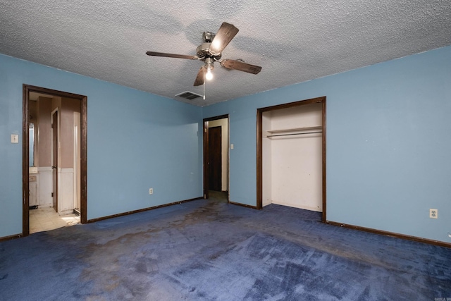 unfurnished bedroom with visible vents, a ceiling fan, a textured ceiling, carpet floors, and a closet