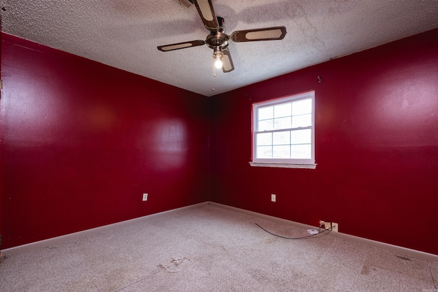 unfurnished room with a textured ceiling, ceiling fan, carpet, and baseboards