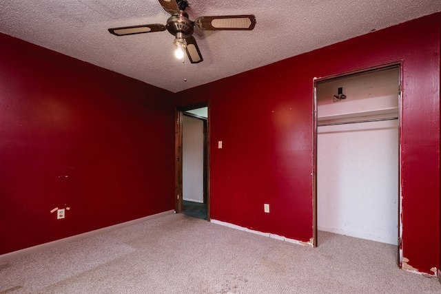 unfurnished bedroom featuring a closet, carpet flooring, ceiling fan, and a textured ceiling