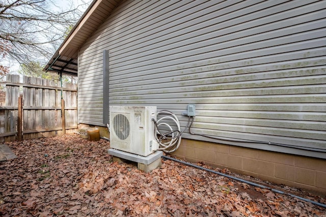 exterior space featuring ac unit and fence