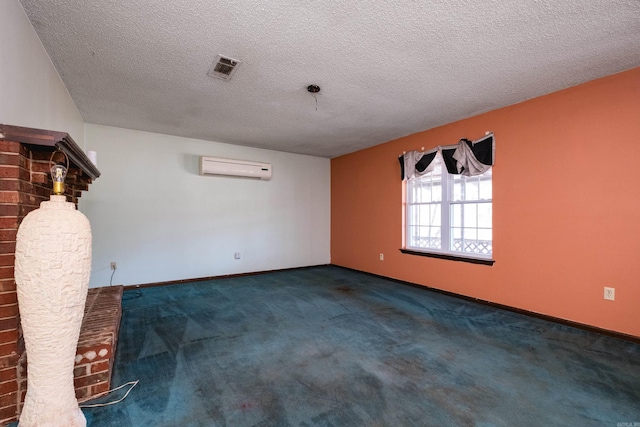 carpeted empty room with a textured ceiling, a wall mounted air conditioner, visible vents, and baseboards