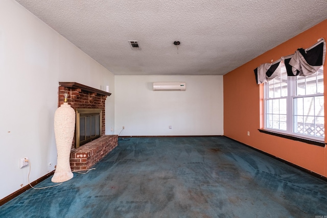 unfurnished living room with visible vents, baseboards, a wall unit AC, carpet, and a fireplace