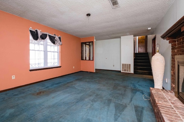 unfurnished living room featuring stairs, a fireplace, visible vents, and carpet flooring