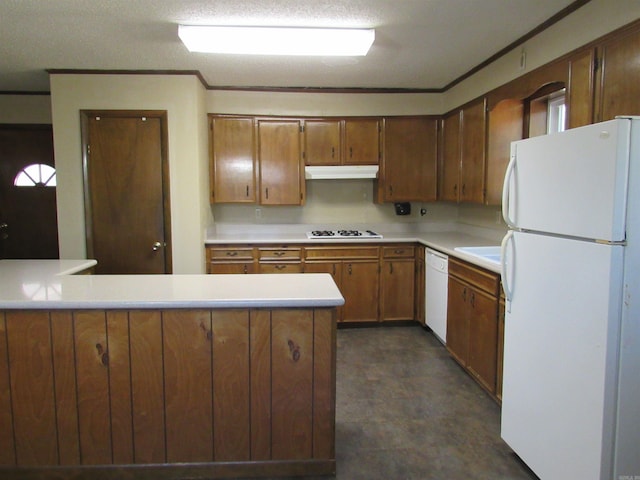 kitchen featuring under cabinet range hood, a peninsula, white appliances, light countertops, and brown cabinets