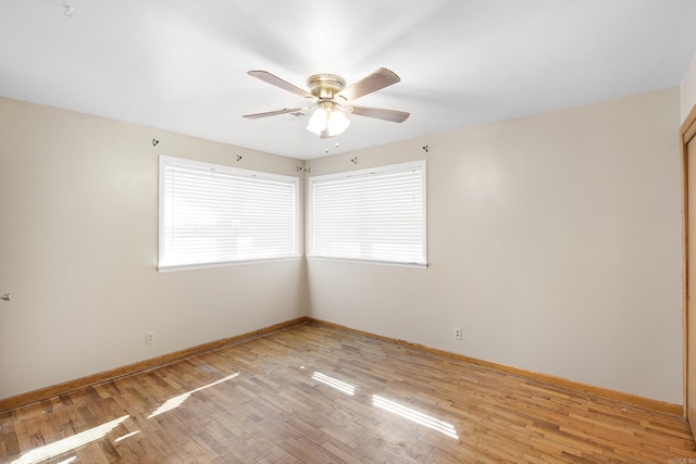 unfurnished room featuring light wood-style floors, ceiling fan, and baseboards