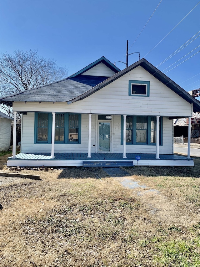 rear view of house featuring covered porch