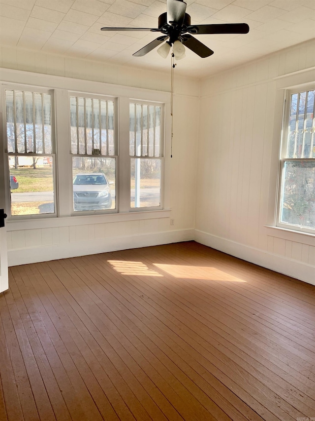 empty room featuring a ceiling fan and hardwood / wood-style floors