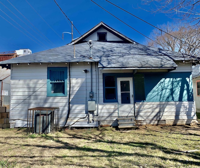 back of house featuring crawl space, entry steps, and a yard