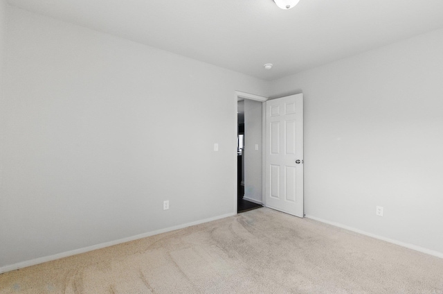 carpeted empty room with baseboards