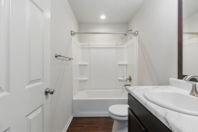 bathroom with bathing tub / shower combination, vanity, toilet, and wood finished floors