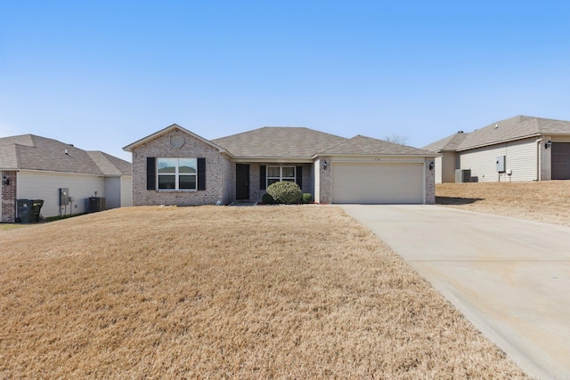 ranch-style home with brick siding, central air condition unit, a garage, driveway, and a front lawn