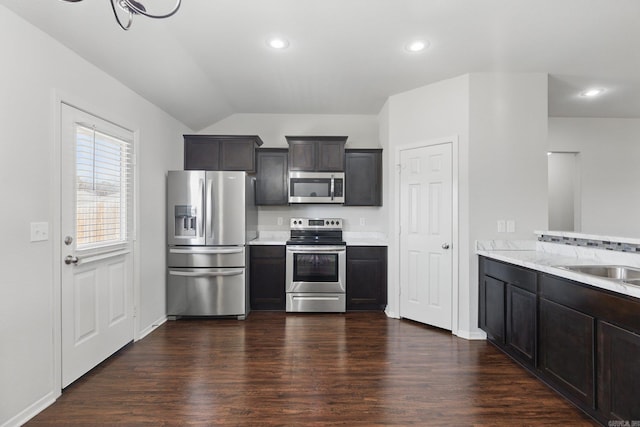 kitchen with stainless steel appliances, light countertops, and dark wood finished floors