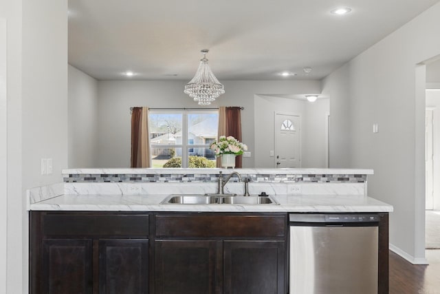 kitchen featuring dishwasher, dark wood-style flooring, light stone countertops, dark brown cabinets, and a sink