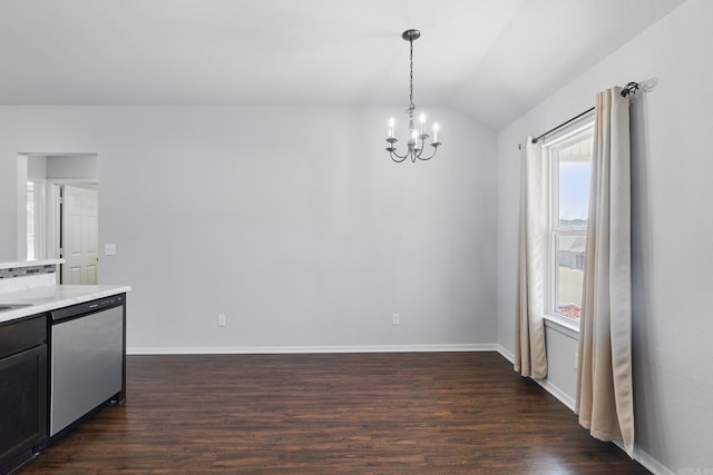 unfurnished dining area with dark wood-style flooring, a notable chandelier, vaulted ceiling, and baseboards