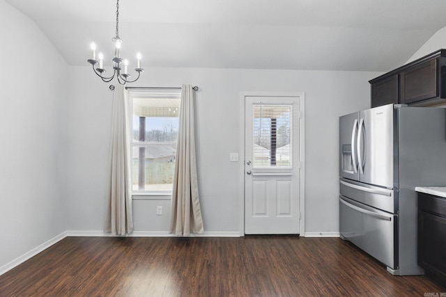 kitchen featuring a notable chandelier, baseboards, vaulted ceiling, stainless steel fridge with ice dispenser, and dark wood-style floors