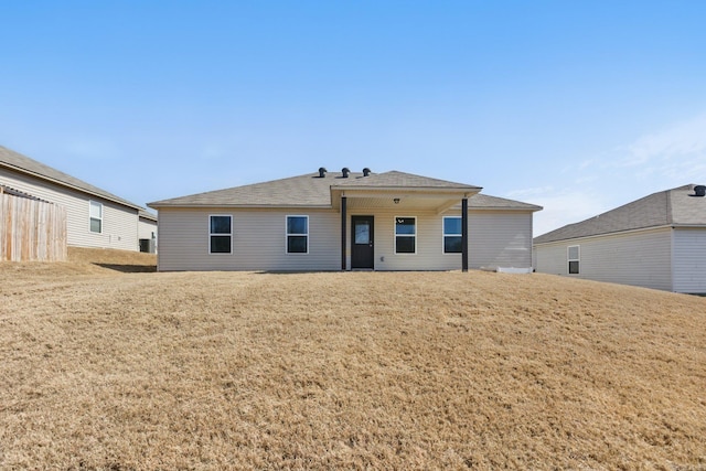 rear view of house with a yard