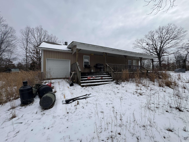 exterior space featuring covered porch and a garage