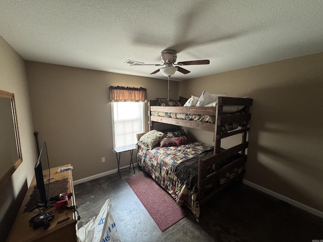 bedroom featuring visible vents, baseboards, ceiling fan, a textured ceiling, and concrete flooring