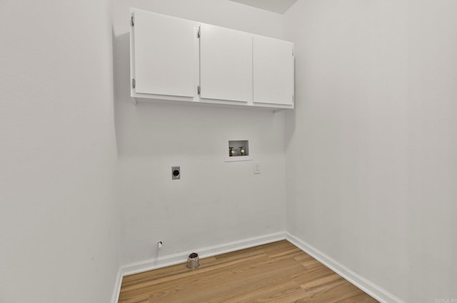 washroom featuring hookup for a washing machine, baseboards, light wood-style floors, cabinet space, and electric dryer hookup