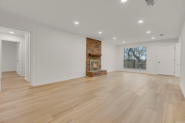 unfurnished living room featuring a fireplace, recessed lighting, visible vents, light wood-style floors, and baseboards