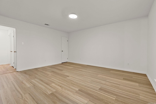 unfurnished room featuring light wood finished floors and baseboards