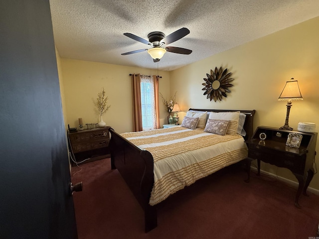 bedroom featuring a textured ceiling, carpet flooring, a ceiling fan, and baseboards