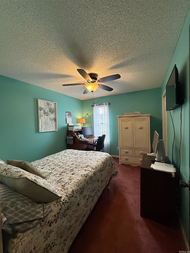 bedroom featuring ceiling fan, dark colored carpet, and a textured ceiling