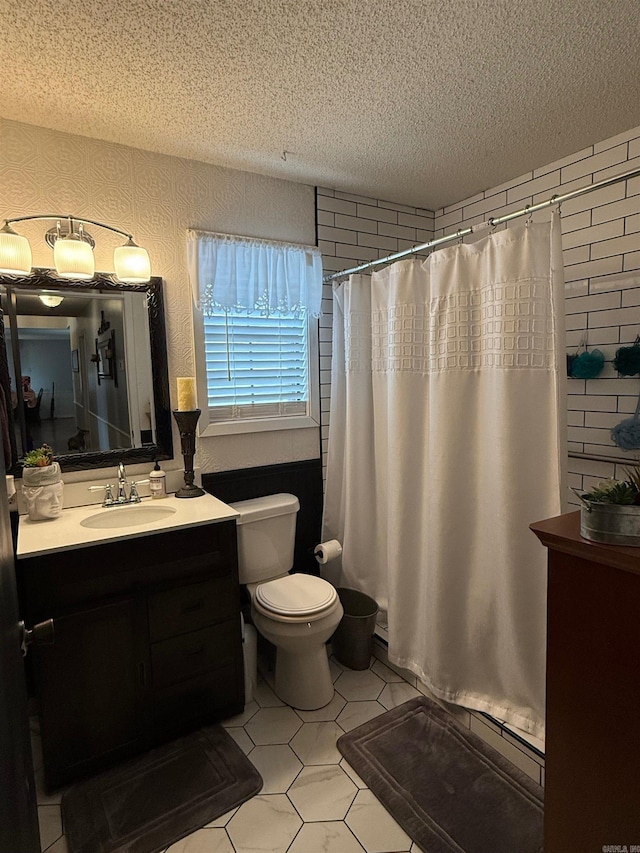 full bath with a shower with shower curtain, toilet, vanity, and a textured ceiling